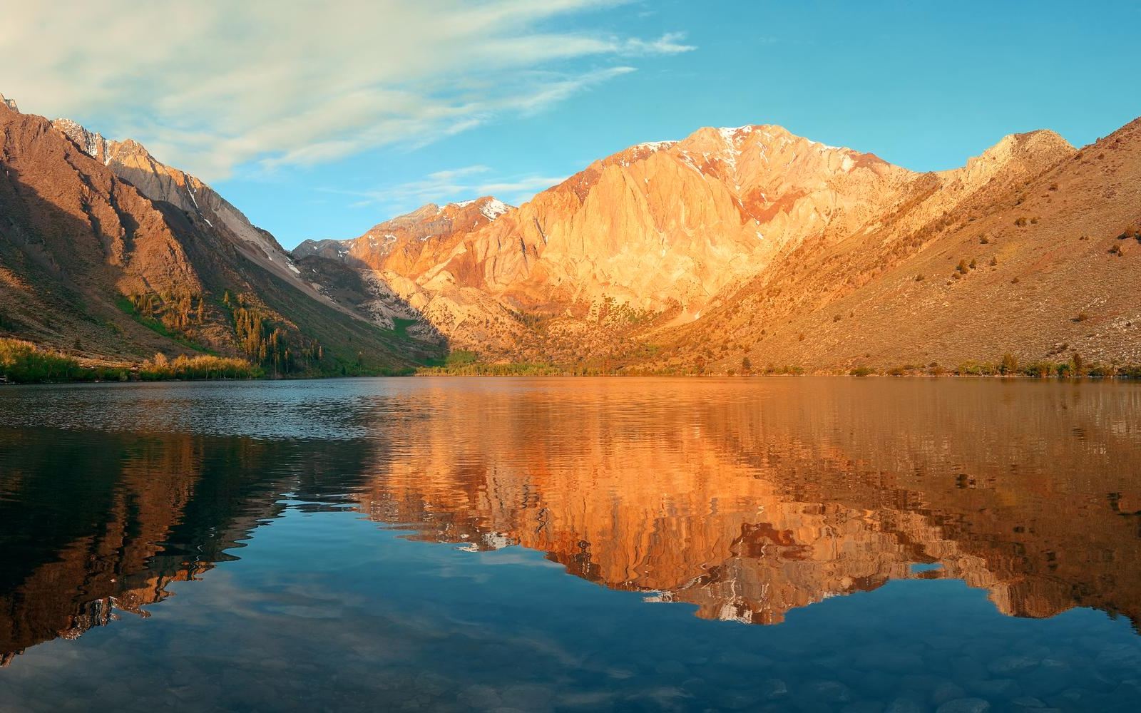 Snow mountain and lake with reflections panorama in yosemite.